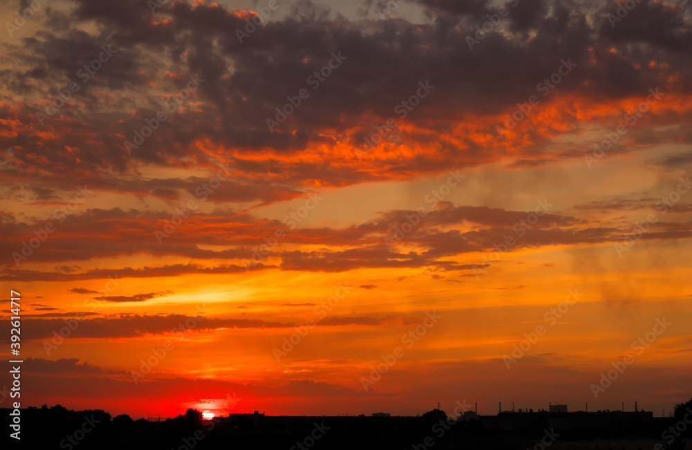 Sky sunset in the evening with colorful orange sunlight. Beautiful majestic nature background