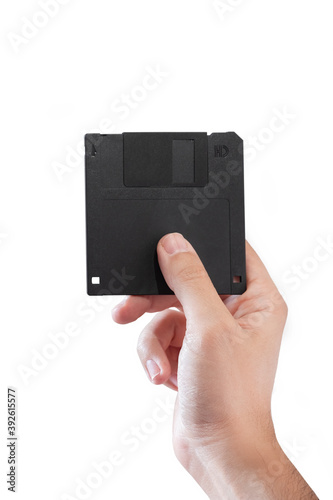 Male Hand Holding A Black Floppy Disk, Isolated On White Background