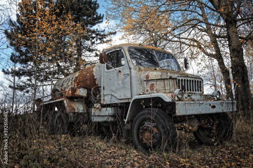 Old abandoned tank truck in the forest