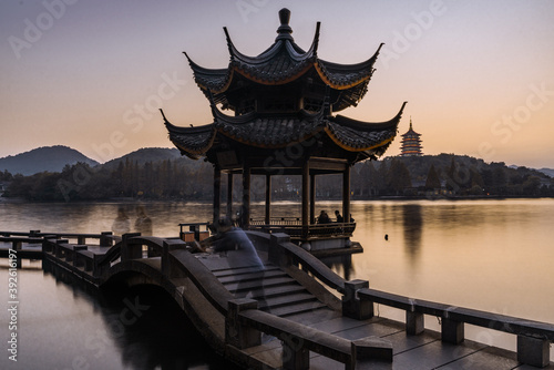 The sunset view of the bridges and towers at the West Lake in Hangzhou, China.