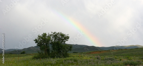 Landscapes of Mongolia. Desert mountain slopes and valleys with rainbow. Photo with copy space.