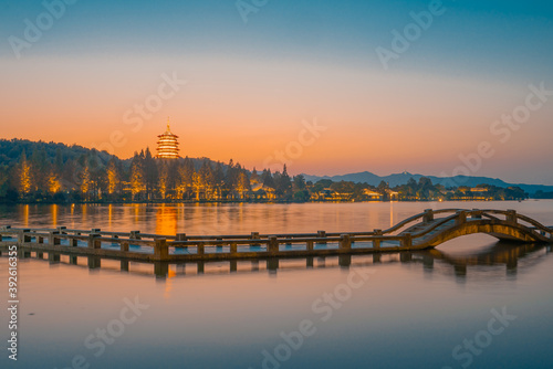 The sunset view of the bridges and towers at the West Lake in Hangzhou, China.