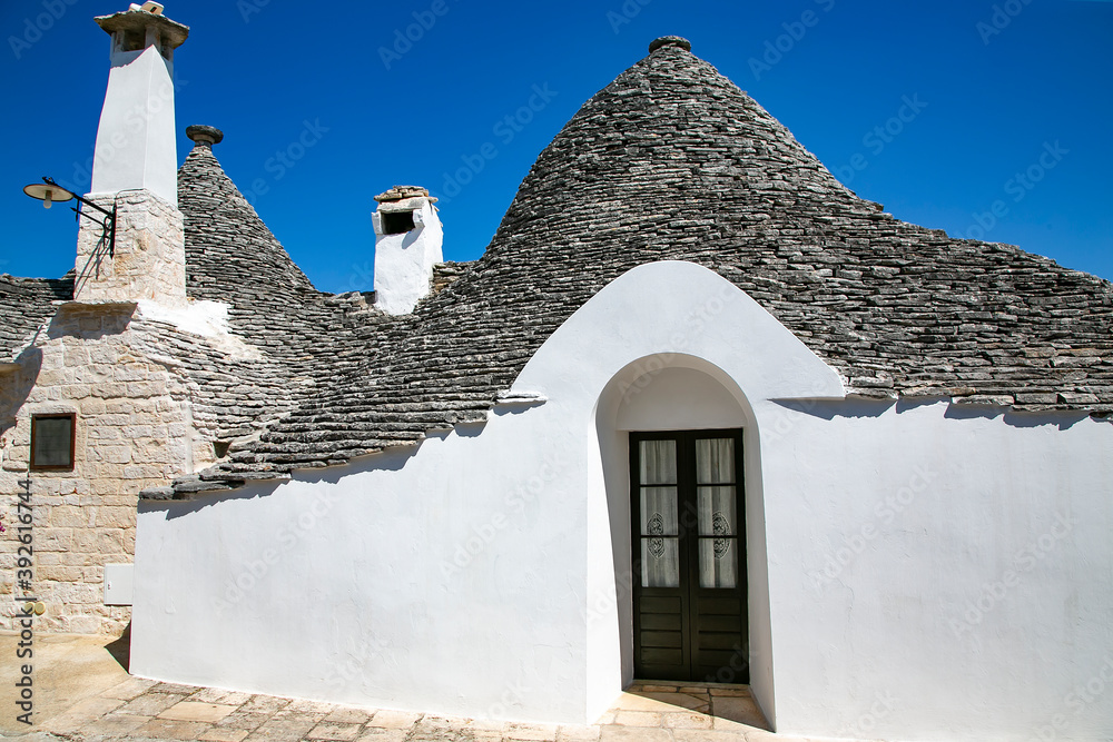 Trulli houses in Alberobello village, Italy. A trullo house is a traditional apulian dry stone hut with a conical roof.