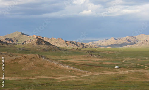 Landscapes of Mongolia. Desert mountain slopes and valleys. Mountain mountain range on the background of the steppe. Photo with copy space.