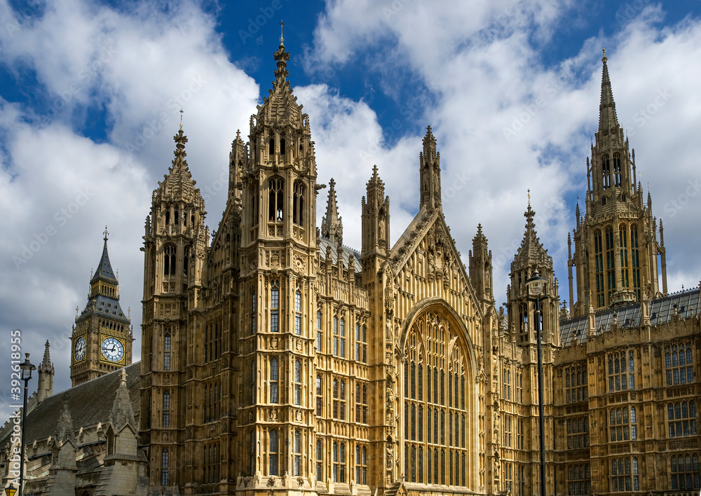 View of the gothic Westminster Abbey with Big Ben in the background, symbols of the city of London.