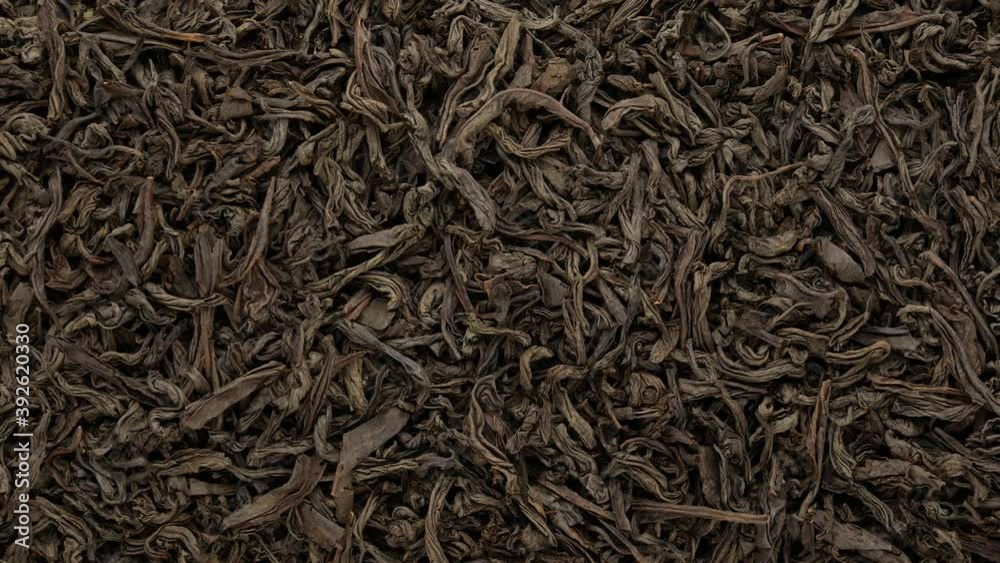 Black tea - background. The tea leaves are dried, top view. Black tea - background. The tea leaves are dried, top view.