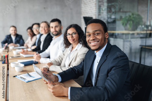 African Businessman On Corporate Meeting With Colleagues Sitting In Office