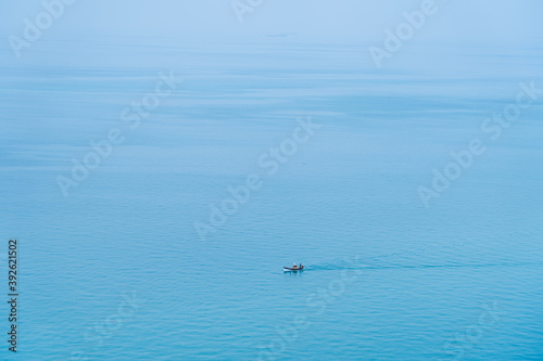 Minimalist fishing boat in the sea ocean. © visitr