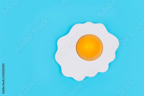 Fried egg on pastel blue background,minimal koncept