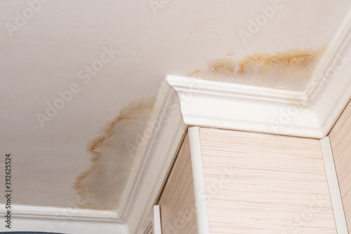 Canvas Print Neighbors have a water leak, water-damaged ceiling, close-up of a stain on the c