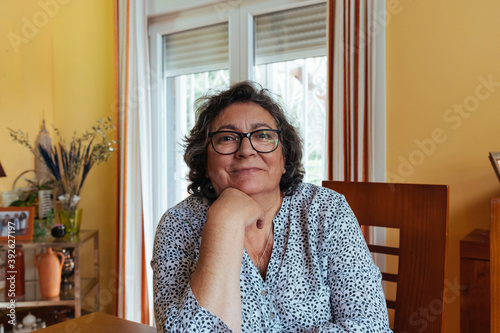 Portrait of a 59 year old woman smiling. Senior people