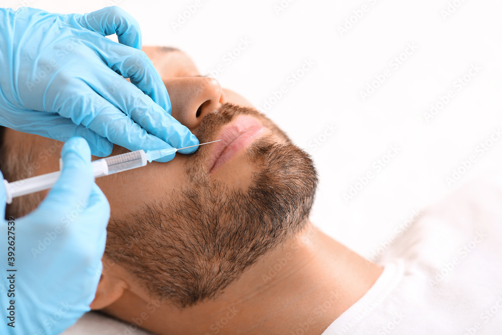 Closeup of man getting lips filler at aesthetic clinic Closeup of man getting lips filler at aesthetic clinic