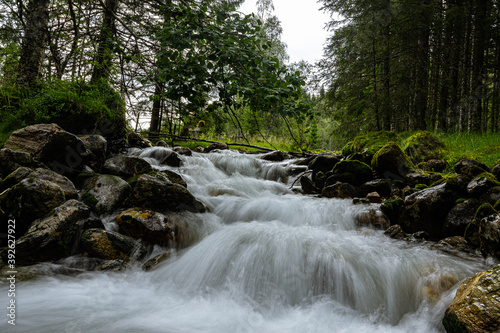 Flowing water over stones in a forest in Norway