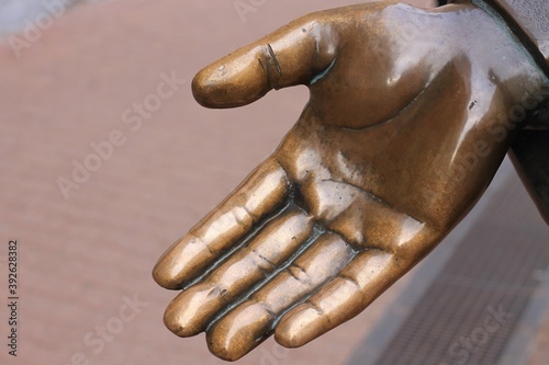 the palm of a bronze statue polished by handshakes