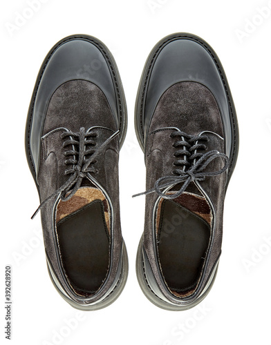 Great pair of brutal men's shoes combined from black suede and waterproof inserts on the toe and heel, on a solid sole, isolated on a white background with shadow. Top view.