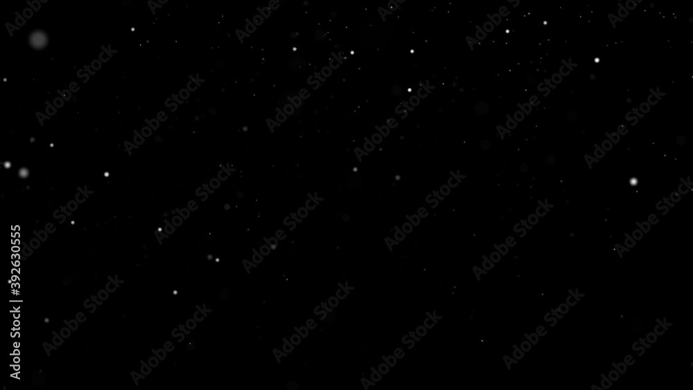 White particles slowly falling like snow in a black background