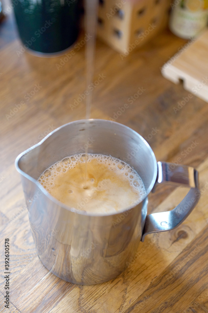Barista prepares coffee in a paper cup Barista prepares coffee in a paper cup