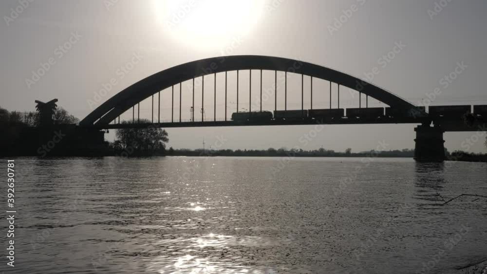 Cargo train driving over Culemborg bridge in the Netherlands, silhouette shot Cargo train driving over Culemborg bridge in the Netherlands, silhouette shot
