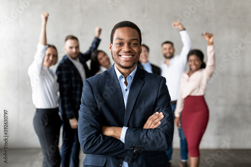 Successful Black Businessman Standing In Front Of Business Team Indoor photo