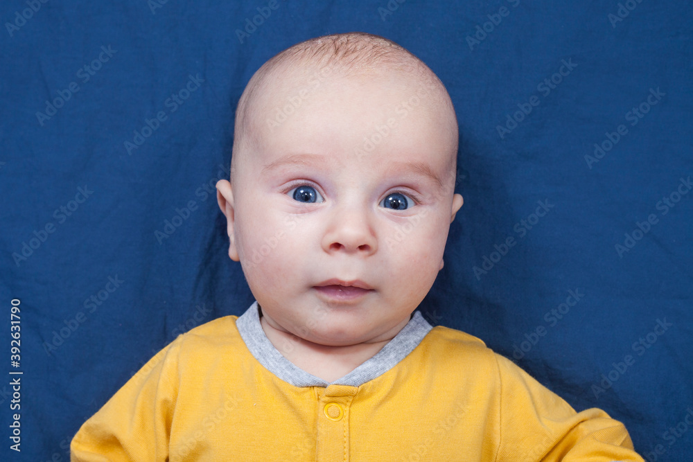 Blue-eyed baby boy on a blue background Blue-eyed baby boy on a blue background