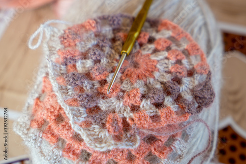 Close-up, grey and multi colored yarns and crochet needle. 