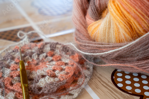 Close-up, grey and multi colored yarns and crochet needle. 