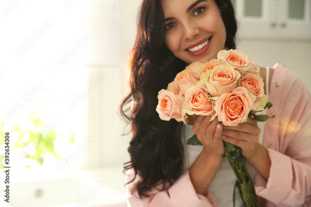 Young woman with beautiful bouquet in kitchen Young woman with beautiful bouquet in kitchen