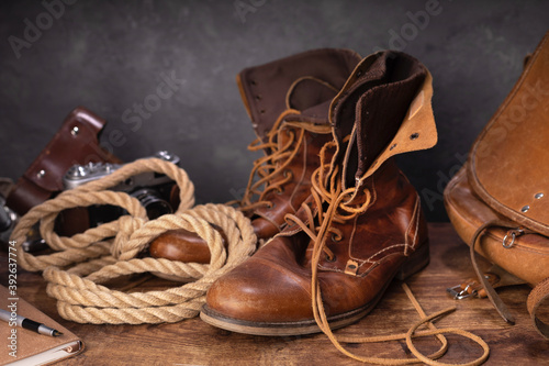 old leather travel vintage boots shoes and bag at  table