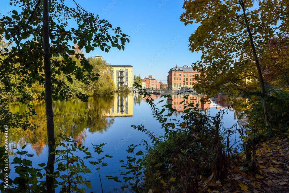 City park Åbackarna and the gistoric industrial landscape along Motala river in Norrköping during fall in Sweden.