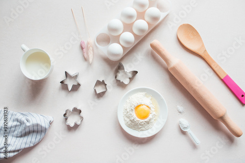 Baking ingredients. Eggs, flour, milk, whisk, rolling pin, bakeware on a white background, top view. cook's workplace in the kitchen. beautiful dishes. Copy space. homemade cookies. Cooking background