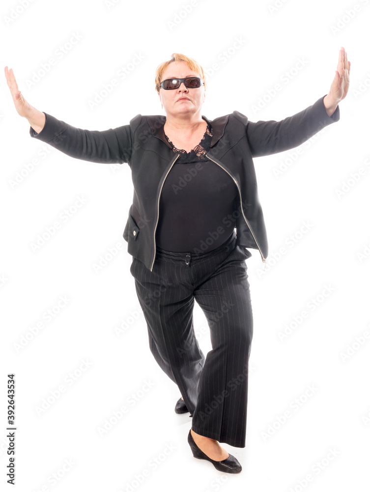 Middle aged woman in black jacket and trousers dancing an emotional dance Middle aged woman in black jacket and trousers dancing an emotional dance