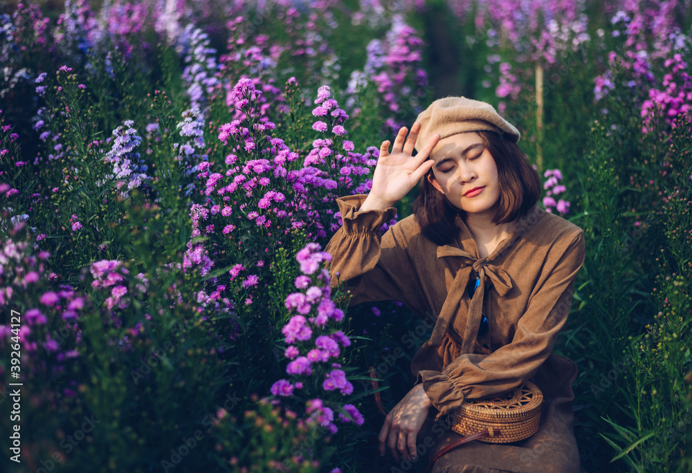 Portrait of young Asian tourist woman standing in Margaret flowers field grows in Mae Rim district, Chiang Mai province of Thailand. Portrait of young Asian tourist woman standing in Margaret flowers field grows in Mae Rim district, Chiang Mai province of Thailand.