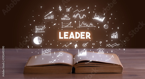 LEADER inscription coming out from an open book, business concept
