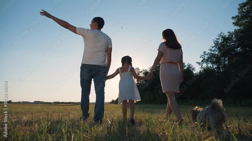 Family walk in lifestyle park. Happy family together in park. family silhouette teamwork child dream concept. Happy child walks with parents. family is enjoying the walk together. Family walk in lifestyle park. Happy family together in park. family silhouette teamwork child dream concept. Happy child walks with parents. family is enjoying the walk together.