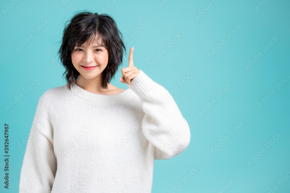 Portrait of pretty woman posing gesture with hands image isolated on aqua blue studio background Portrait of pretty woman posing gesture with hands image isolated on aqua blue studio background