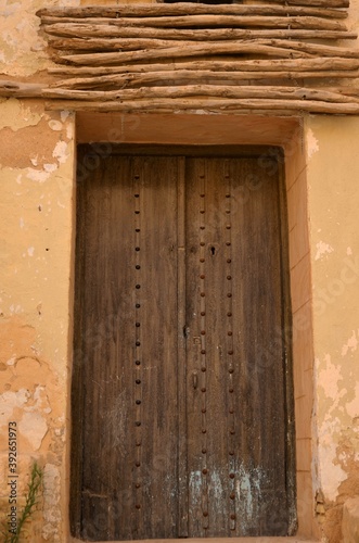Kairouan, Tunisia. 06/11/2019. Old Traditional wooden brown aged Tunisian door with ornament in Kairouan Medina