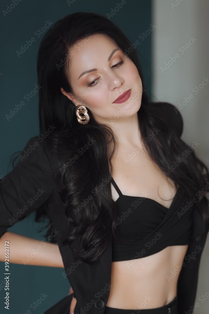 Portrait of beautiful young woman with makeup in black      
Fashion photo