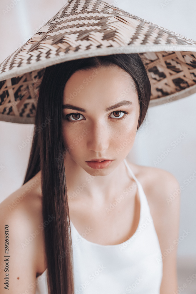 Portrait of beautiful young girl with natural beauty. Girl in bamboo vietnamese hat Portrait of beautiful young girl with natural beauty. Girl in bamboo vietnamese hat
