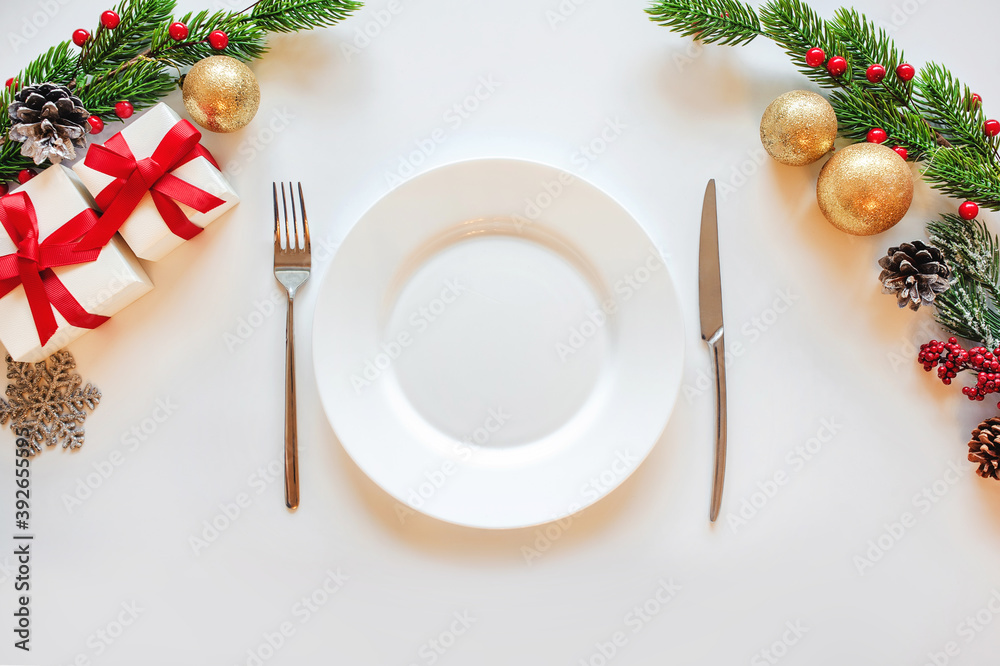 2021 year celebration with table setting, presents, decoration, balls, fir tree on white background top view 2021 year celebration with table setting, presents, decoration, balls, fir tree on white background top view