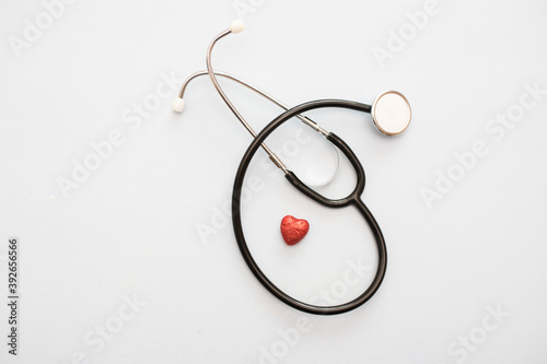 Stethoscope, pills, heart. Isolated over white background. The concept of medicine.