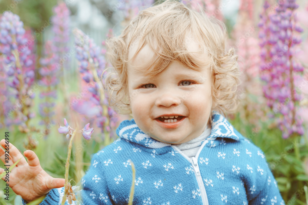 a child plays among the grass
