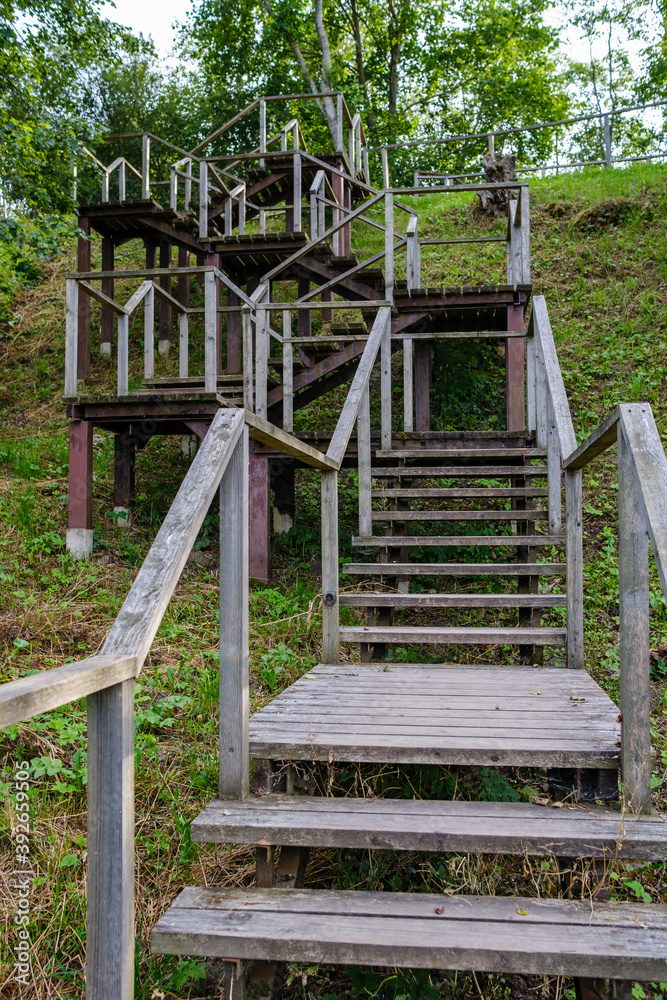 wooden boardwalk trail in green forest wooden boardwalk trail in green forest