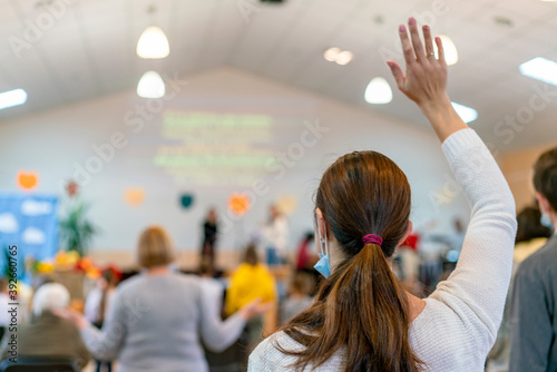 People praying in a church. soft focus of christian people group raise hands up worship God Jesus Christ together in church. selected focus