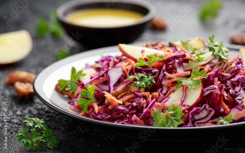 Red Cabbage salad with carrots, apples and pecan nuts. Healthy vegan food