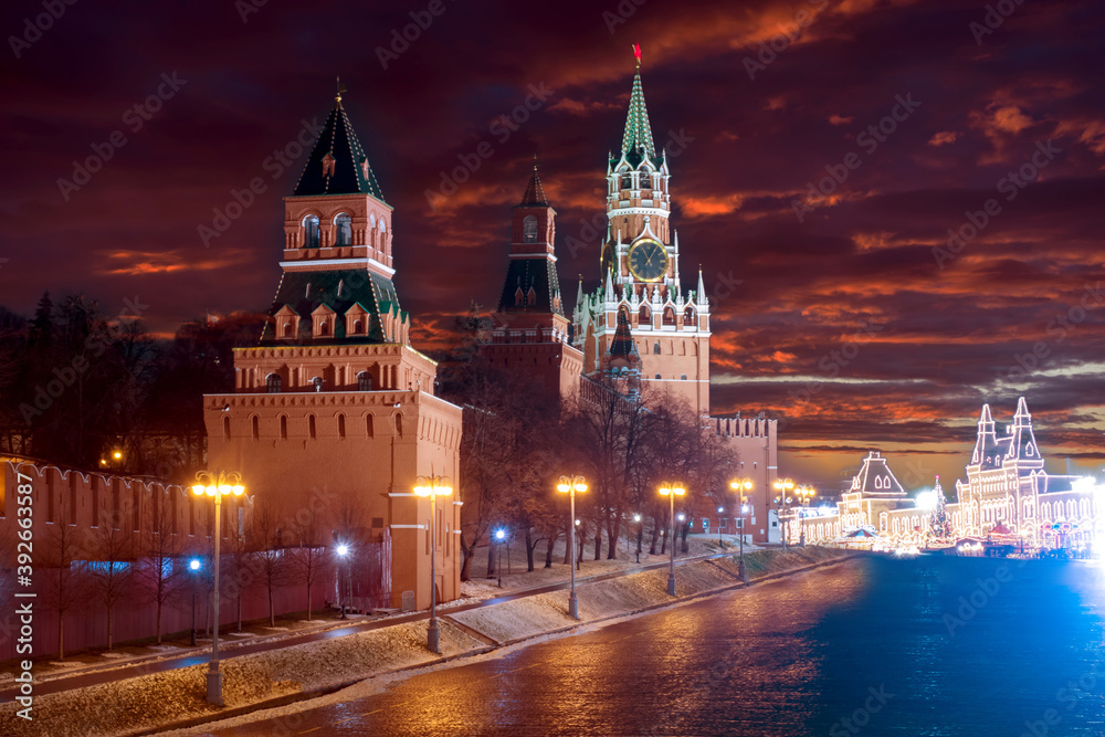 Fototapeta premium New year in Moscow. Christmas in Russia. The Kremlin under a dramatic sky. New year's eve in Moscow. evening Moscow. Christmas market in the distance. Cities Of The Russian Federation.