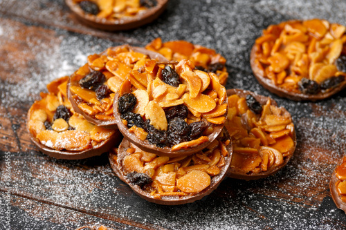 Fototapeta Christmas Chocolate Florentines cookies with almond and raisins with decoration,
