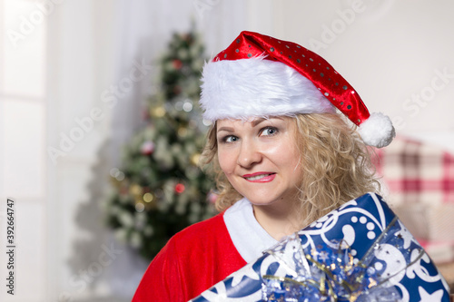 Cheerful woman dressed in Santa Claus costume