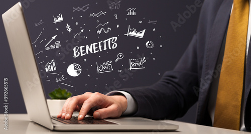 Businessman working on laptop with BENEFITS inscription, modern business concept