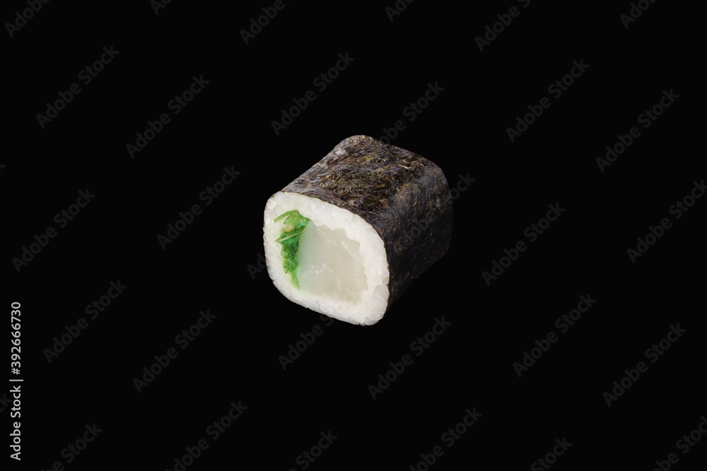 hosomaki roll with chuka seaweed and scallop isolated on black hosomaki roll with chuka seaweed and scallop isolated on black