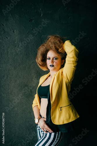 Young fashion clown girl posing in studio